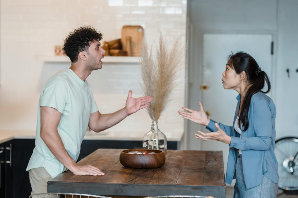 a couple arguing in their kitchen