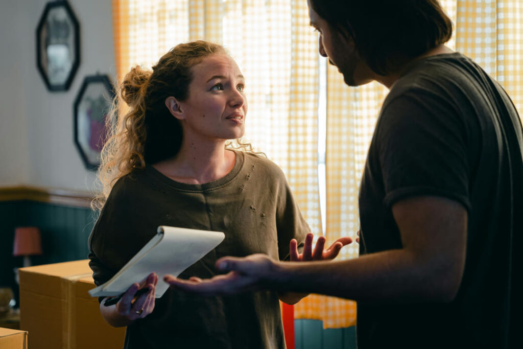 a girl arguing with her husband with a notepad in her hand