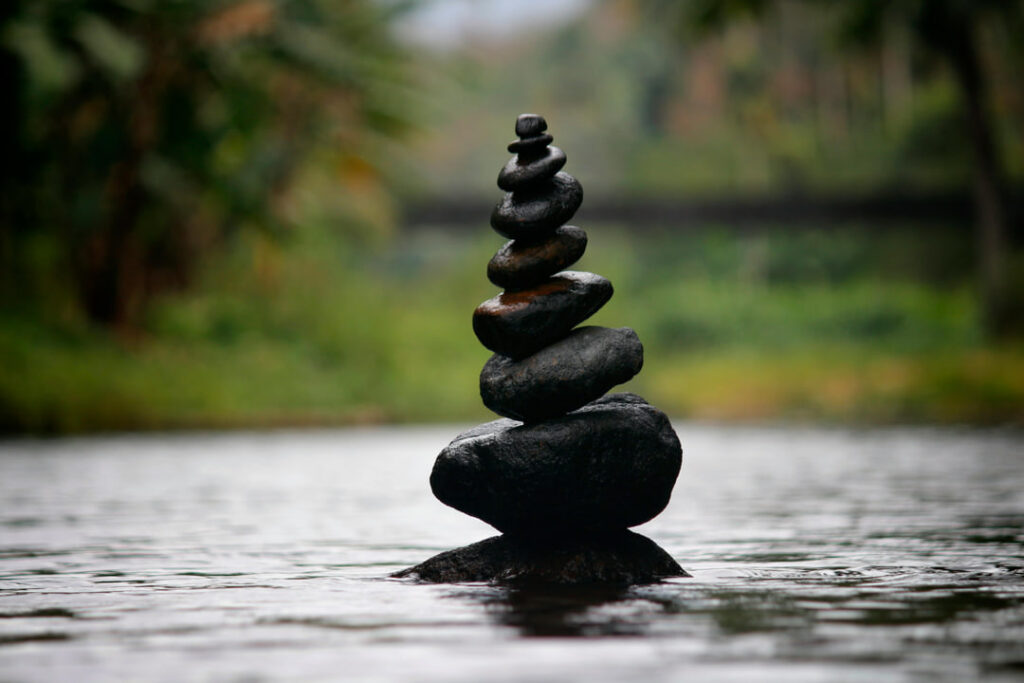 rocks balancing on each other in the water