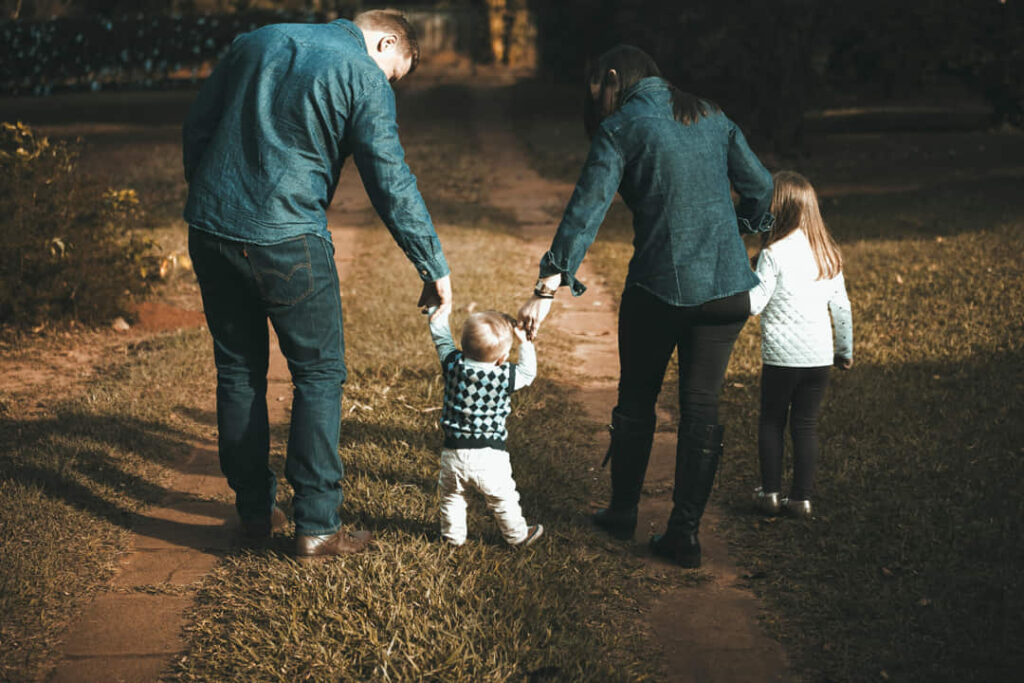 parents on a walk with their 2 kids