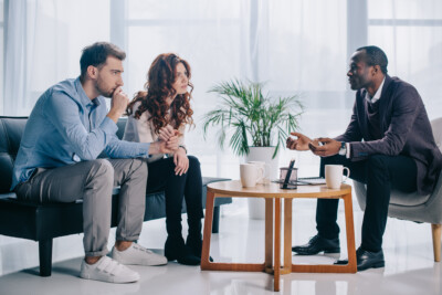 couple sitting and speaking with a therapist