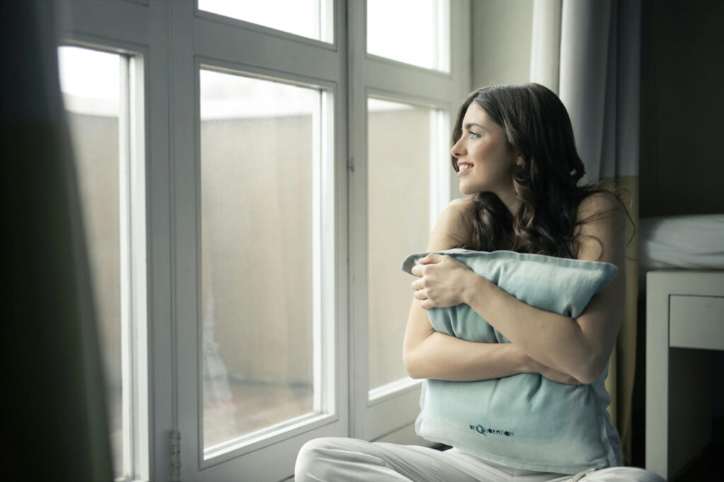 a girl looking out of her window with a smile