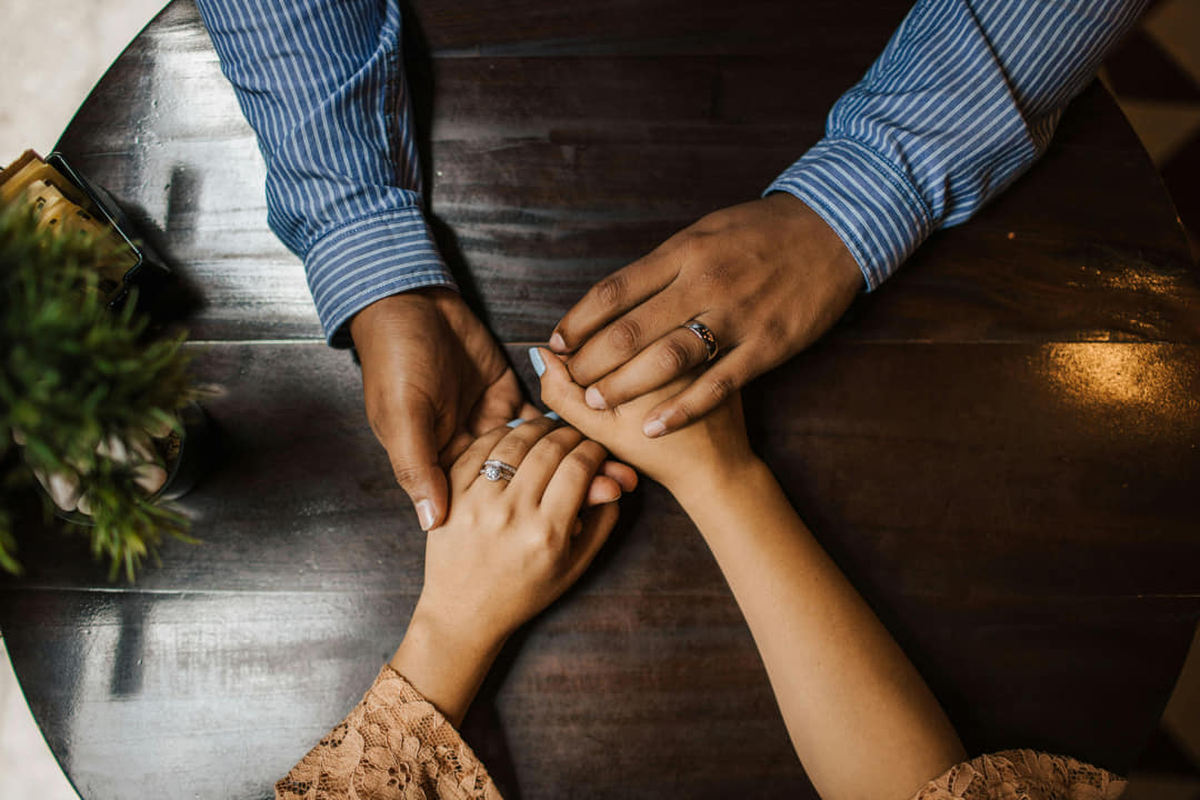 a pair of married hands holding each other