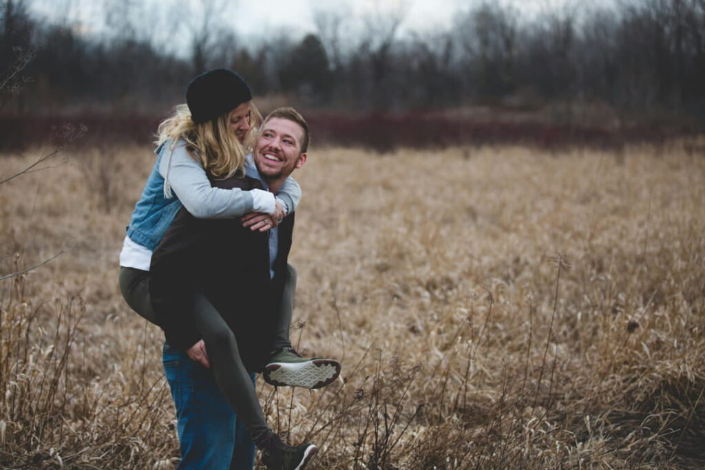 a couple in a field having fun together