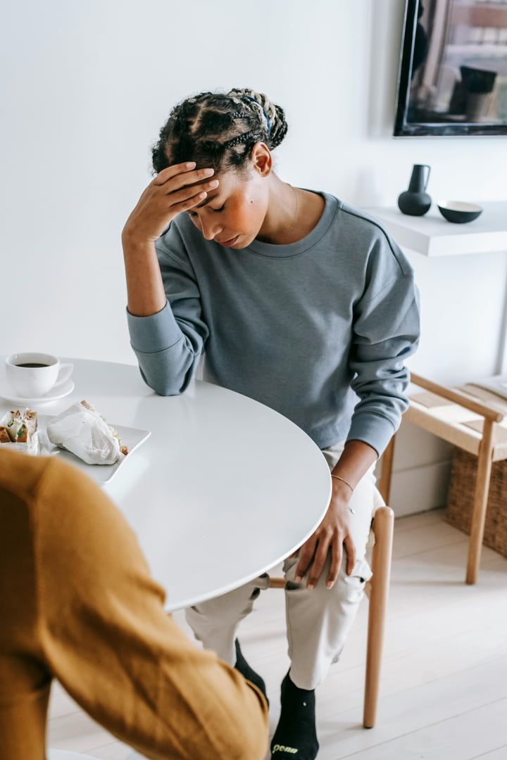 a woman is upset at the table, clearly hurt