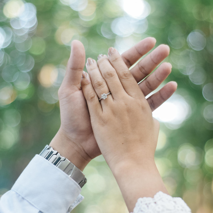 a couple holding hands in the air